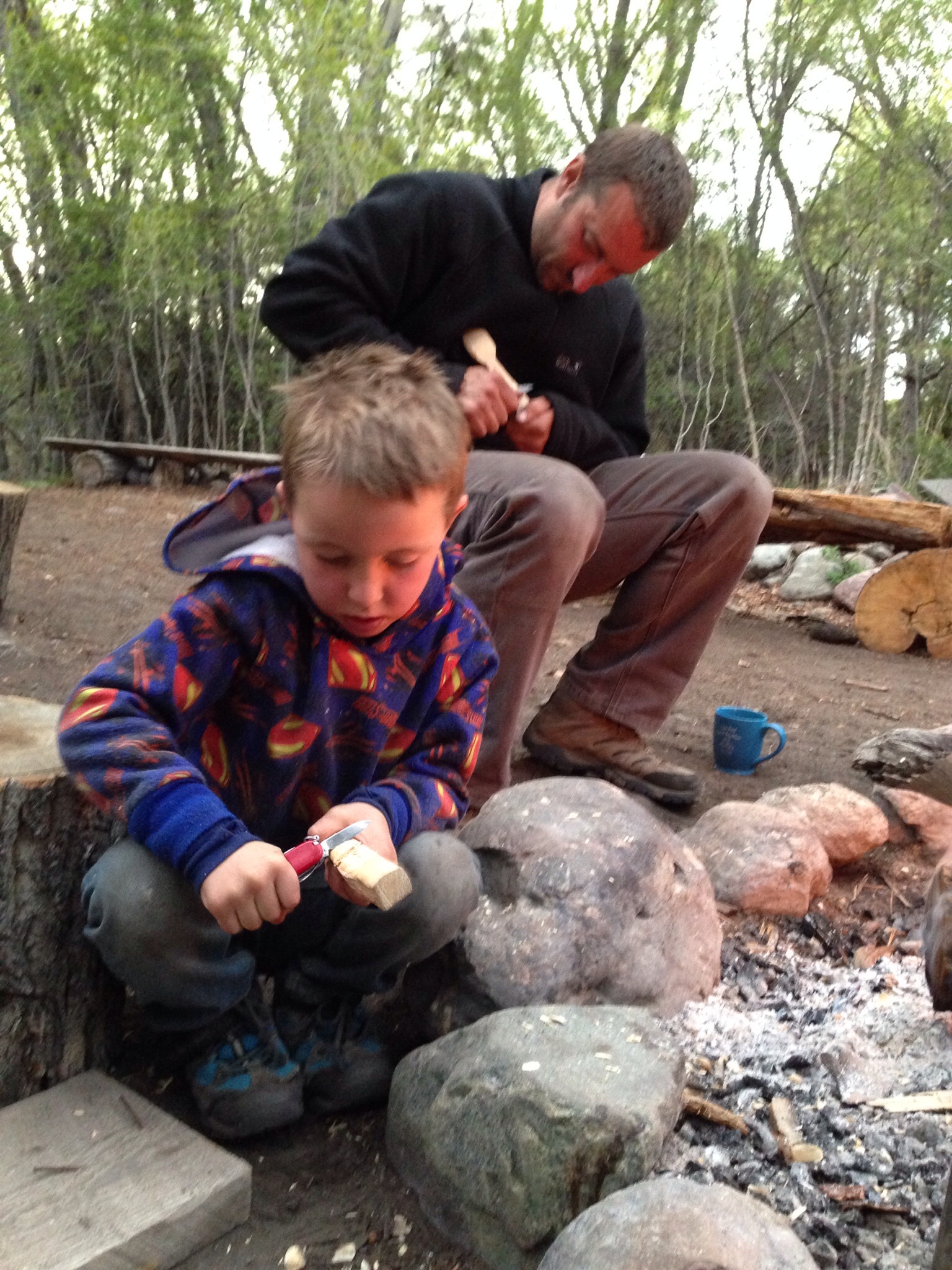 Alfie carving a spoon at Earth Knack